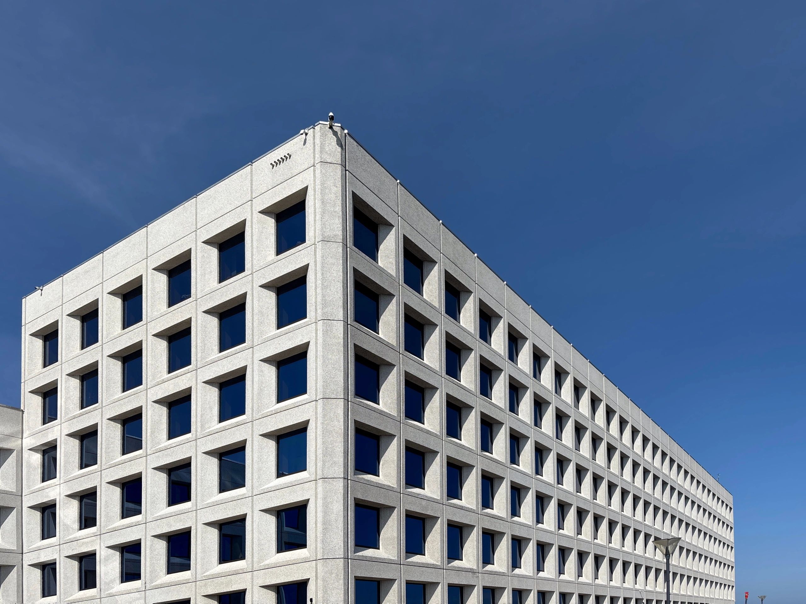 Fachada moderna em tons neutros, usada como imagem institucional genérica.